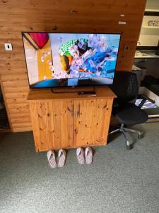 a tv on top of a wooden desk with a chair at Large Private En-suite Space in Grays Thurrock