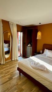 a bedroom with a large bed and a mirror at Jimmy Pyramids Hotel in Cairo