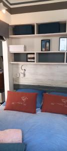 um quarto com duas almofadas vermelhas numa cama em bienvenue au Manava em La Grande-Motte