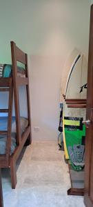 um quarto com 2 beliches e uma prancha de surf em Casa Kapai em Nosara