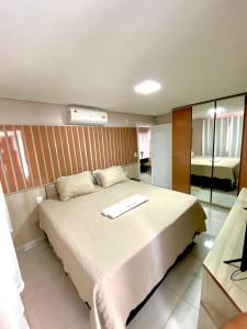 Un dormitorio con una cama grande con una toalla. en Residencial renaissance, en Boa Vista