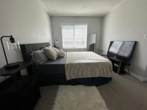 a bedroom with a bed and a flat screen tv at Cozy Whitby Retreat in Whitby