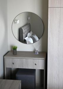 a mirror on top of a table in a room at ALTA MARE in Nea Peramos