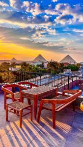 a group of benches and tables on top of a building at Jimmy Pyramids Hotel in Cairo