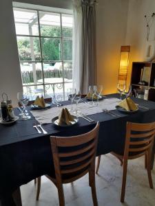 a dining room table with a black table cloth and glasses at Finca Valentina in El Encón