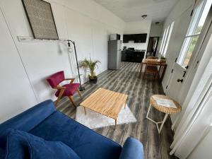 a living room with a blue couch and a table at Rancho Dominique Valle de Guadalupe in Valle de Guadalupe
