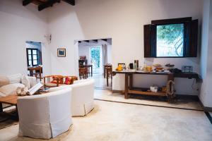 a living room with white chairs and a table at Finca Valentina in El Encón