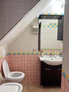 a bathroom with a sink and a toilet and a mirror at Dimora Marilena in Termoli +13 photos