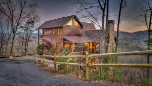 a wooden house with a fence in front of it at Seven Turns to Sunrise in Blue Ridge