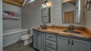 a bathroom with two sinks and a toilet and a tub at Seven Turns to Sunrise in Blue Ridge +45 photos