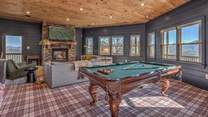a living room with a pool table in a house at Seven Turns to Sunrise in Blue Ridge