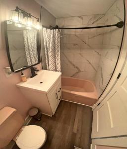 a bathroom with a sink and a toilet and a tub at 2-Bedroom 2-Bath Cozy Home in Nashville's Vibrant in Nashville