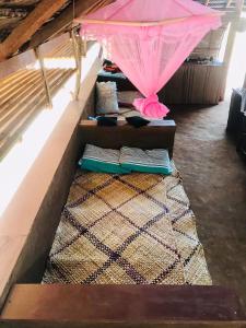 a row of pillows and an umbrella in a room at Ego Swargarajje Yala Thissamaharama in Tissamaharama