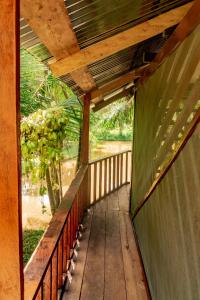 a wooden porch with a view of a river at Cabañas Dechi in Puerto Nariño