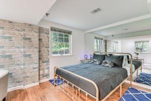 a bedroom with a bed and a wooden wall at Cozy and Pet-Friendly Studio 24 Mi to National Mall in Beltsville