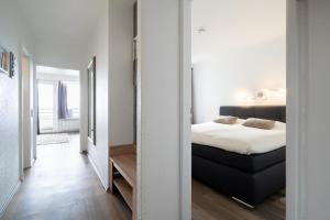 a bedroom with a bed and a large mirror at Ferienpark Sierksdorf App 347 - Strandlage in Sierksdorf