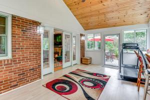 a living room with a brick wall and a rug at Eclectic Home with Private Hot Tub 14 Mi to DC! in Beltsville