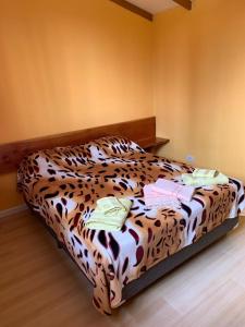 a bed with a leopard print in a room at Camping El Bolsón in El Bolsón