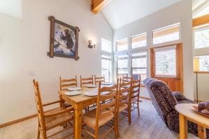 a dining room with a wooden table and chairs at 593 New June Lake Condo in June Lake