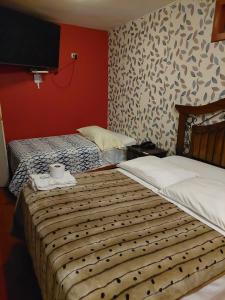 Cama o camas de una habitación en Hostal COLUMBIA