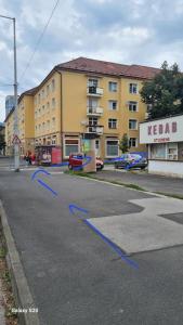 an empty street with blue arrows on the road at Apartmán BB-Centrum1 in Banská Bystrica
