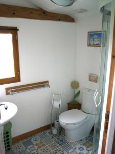 a bathroom with a toilet and a sink at Acacia in Cherbonnières