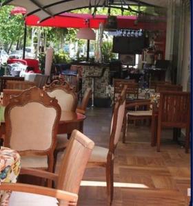 a restaurant with chairs and a table and a tv at KOSA OTEL in Marmaris