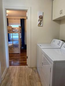 a kitchen with a washing machine in a room at Historic Downtown Cottage in Astoria, Oregon