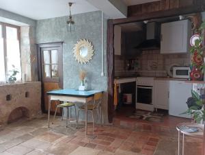 a kitchen with a table and chairs in a room at Mine d'Ore in Thoste