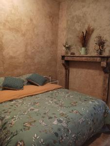 a bedroom with a bed and a shelf on the wall at Mine d'Ore in Thoste