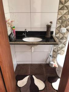 a bathroom with a sink and a toilet at Casa Iriri in Anchieta