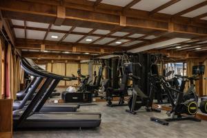 a gym with several treadms and cardio machines at Hotel Los Ñires in Ushuaia