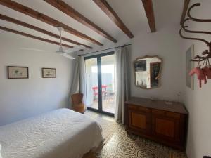 a bedroom with a bed and a large window at Costa Blanca belle maison entre mer et montagne in Adsubia