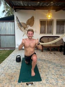 a man is sitting on a green mat at Bella Vista Hotel Boutique in San Miguel