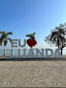 a large sign with a heart in front of it at The Queen in Luanda