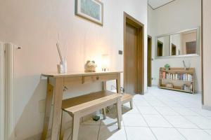 a room with a wooden table and a book shelf at QUEEN HOME Bianca in Bologna