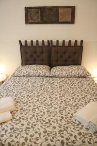 a bedroom with a large bed with a brown headboard at B&B Mia - Only self check-in in Trento
