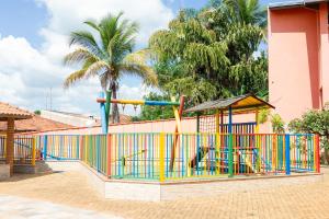 a colorful playground with a slide in front of a building at pousada Anna Assumpta in Severínia