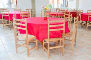 a table and chairs with a red table cloth at pousada Anna Assumpta in Severínia