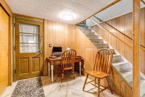 a room with a desk and two chairs and a staircase at Pet-Friendly Lincoln Home 1 Mi to Gateway Mall in Lincoln