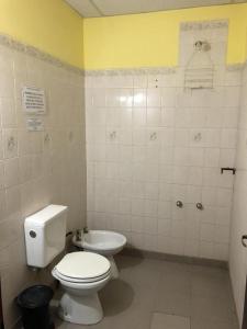 a bathroom with a toilet and a sink at Hosteria Sol de la quebrada in Humahuaca