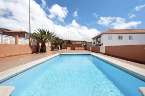a swimming pool in the backyard of a house at Apartamento Caletillas in Candelaria