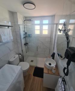 uma casa de banho com um chuveiro, um WC e um lavatório. em Apartamento Caletillas em Candelaria
