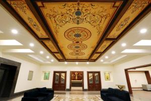 a room with a ceiling with a painting on it at Hotel Meridien in Gujrānwāla