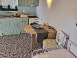 a small kitchen with a table and a stove at Villa Kaliva Family house in Astris +14 photos