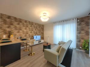 a living room with a desk and a table with a chair at sacha's house ,à coté du RER,val d'europe,Paris-Disney . in Bussy-Saint-Georges +36 photos