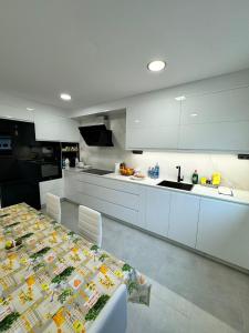 a kitchen with a table and a counter top at Cortiñas in Villalba +6 photos