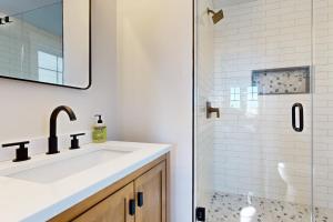 a bathroom with a sink and a shower at Mountain Sunset Villa in Waterville Valley +43 photos