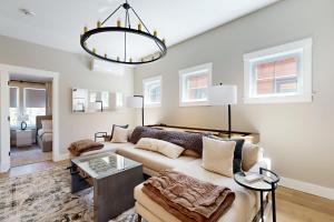a living room with a couch and a chandelier at Mountain Sunset Villa in Waterville Valley