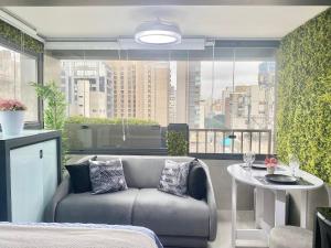 a living room with a couch and a table at Ap luxo Jardins Pamplona cd 1111 in Sao Paulo